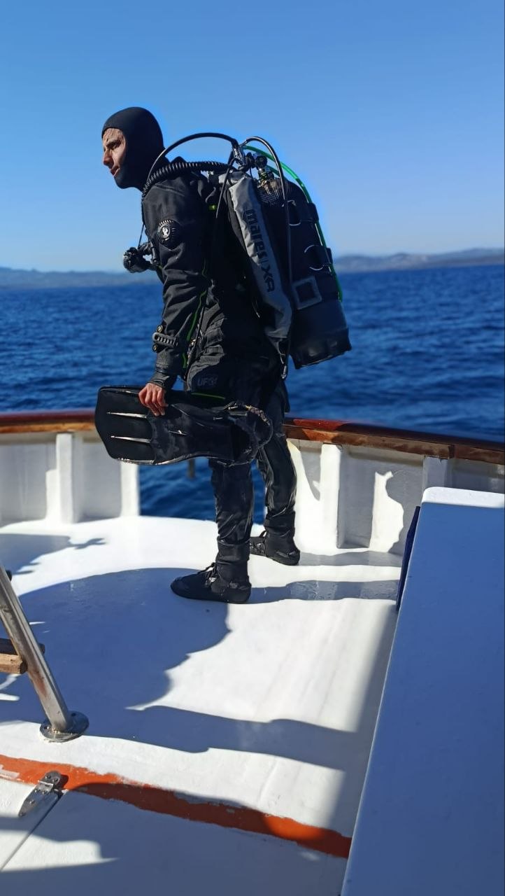 Taucher mit Ausrüstung an Bord vor Sardinien